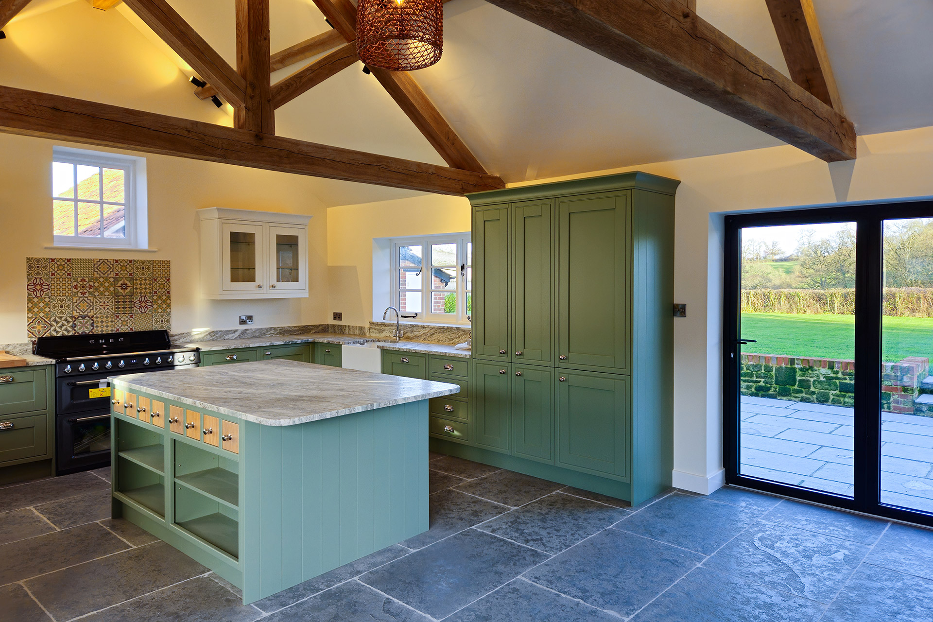 modern kitchen extension with exposed beams and sliding door onto patio