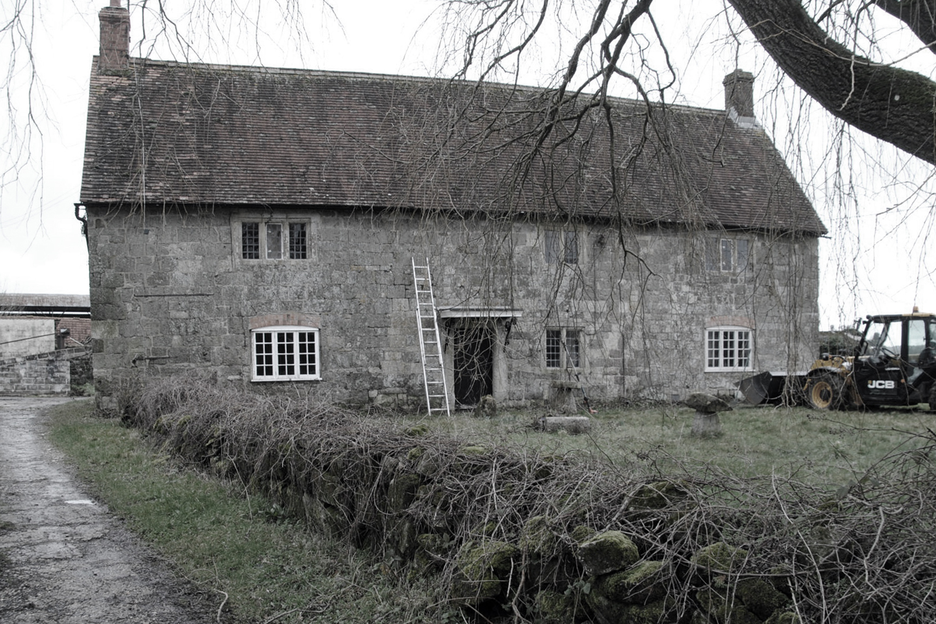 before photo of detached stone house