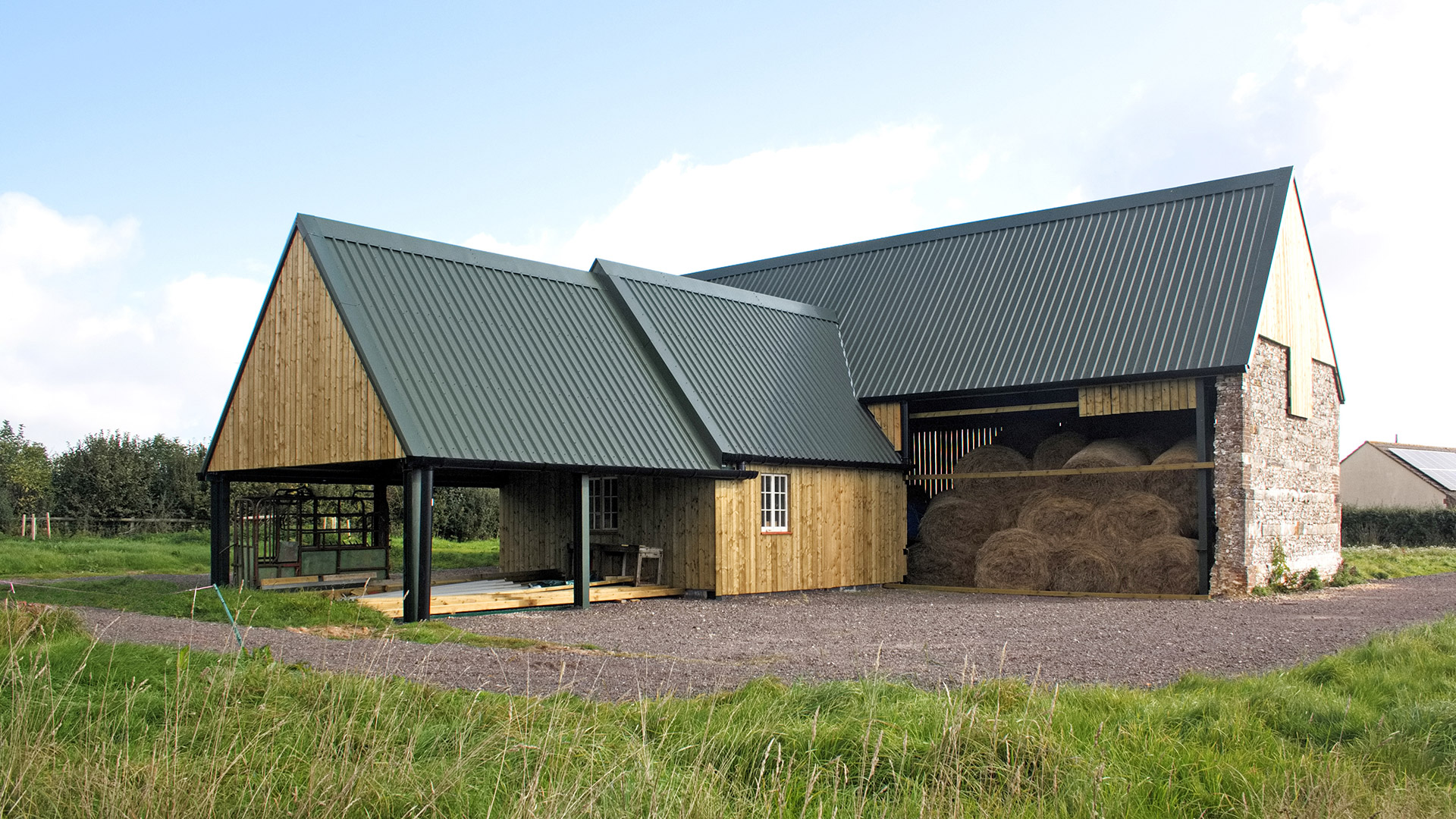 agricultural steal framed barn with timber cladding and stone wall