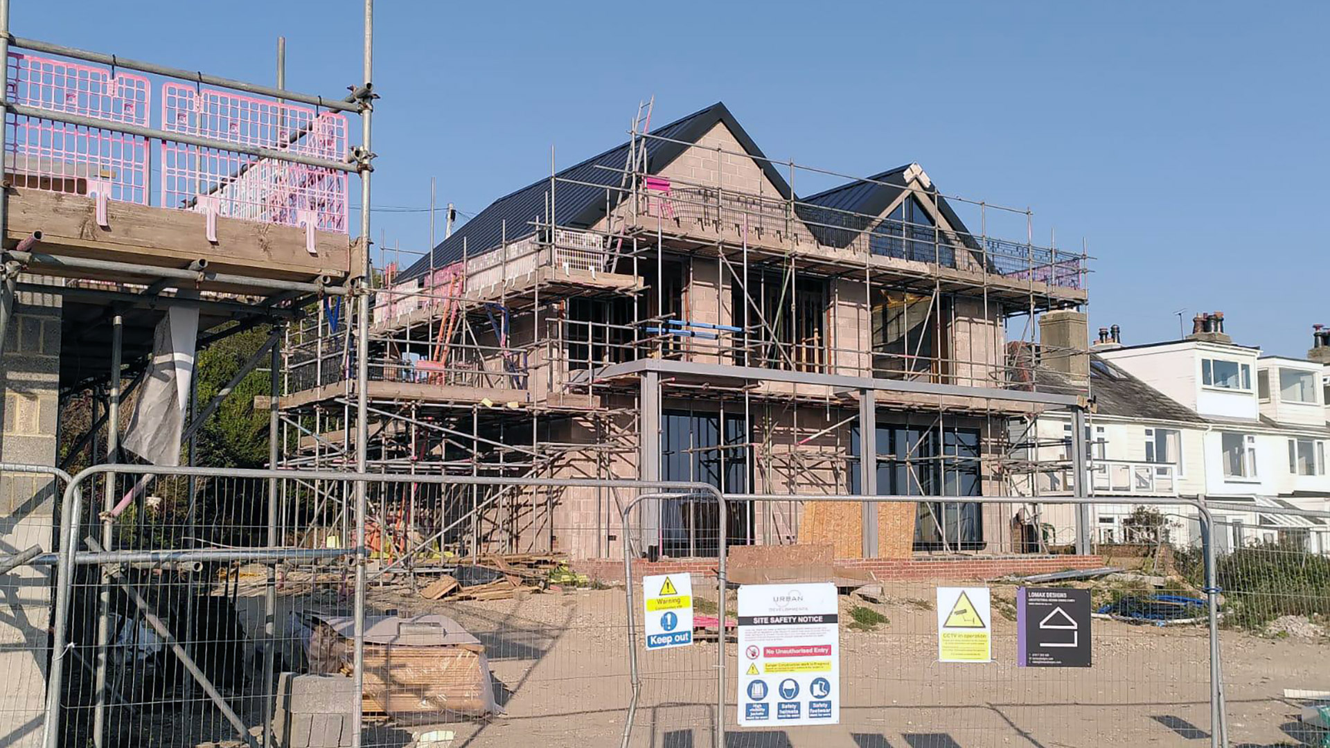 modern house under construction with scaffolding
