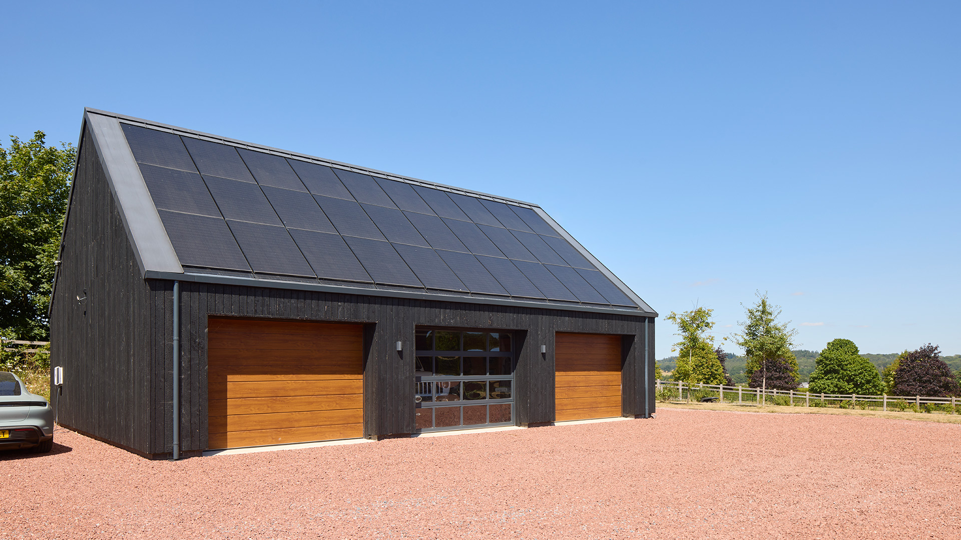 Triple garage with photovoltaic panels on roof