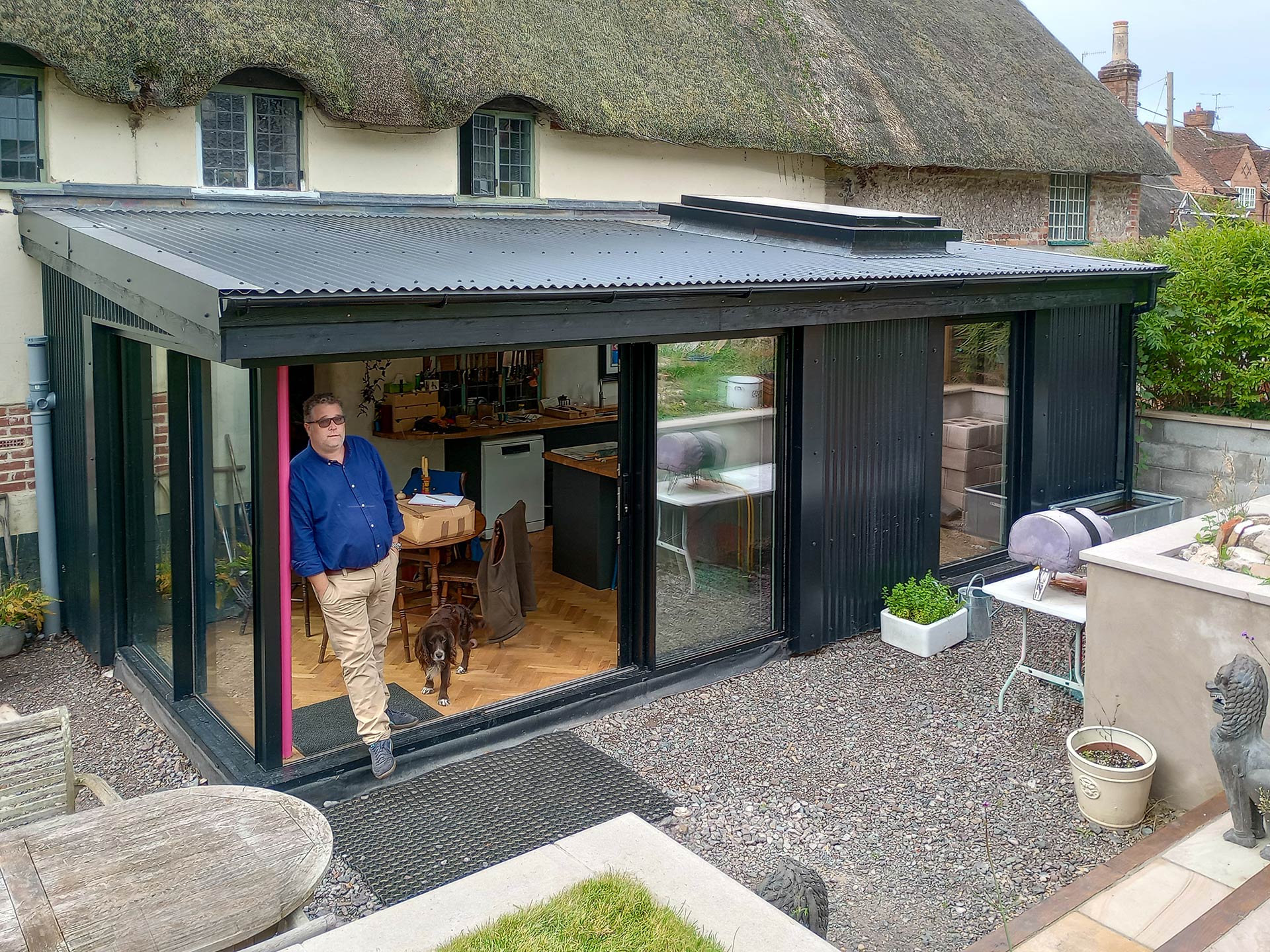 corrugated roof extension to thatched cottage