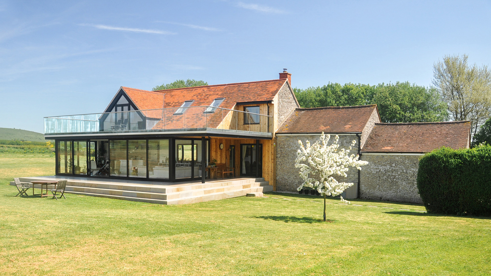 contemporary extension with balcony on traditional stone building