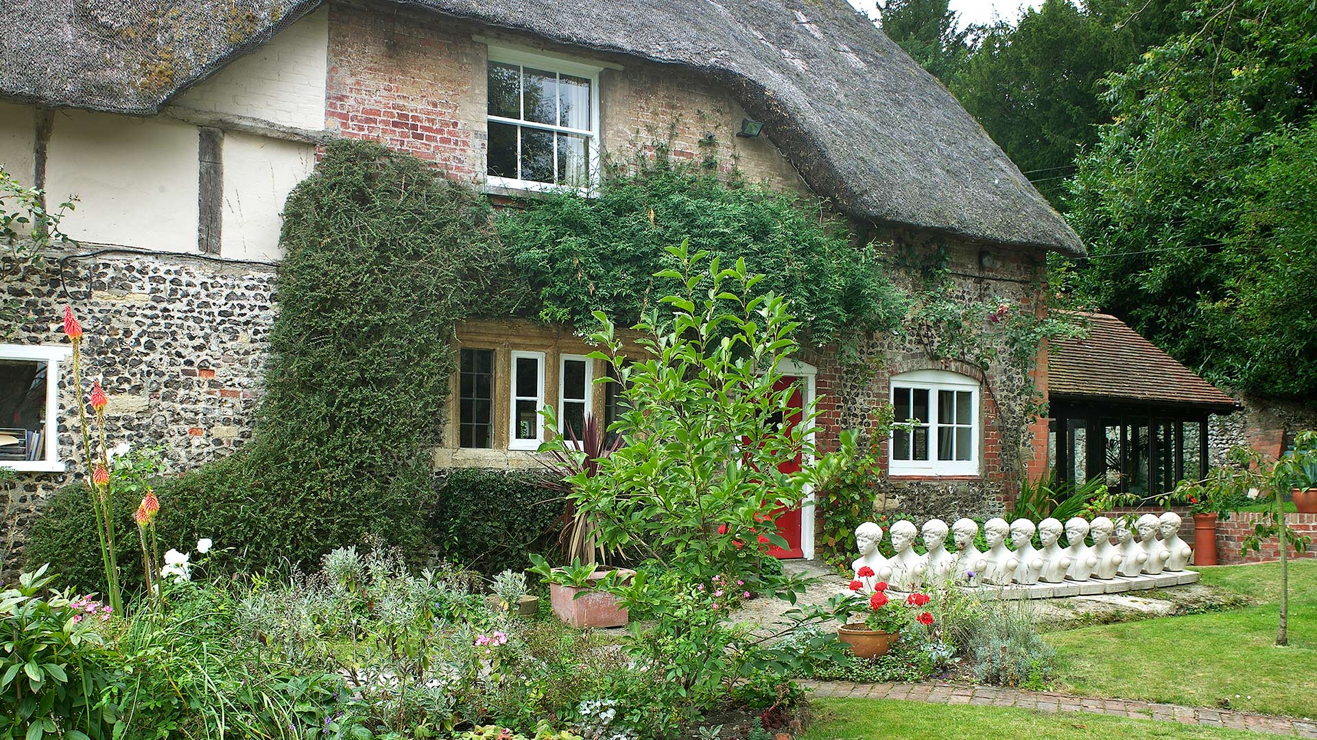front view of listed thatched cottage with garden extension