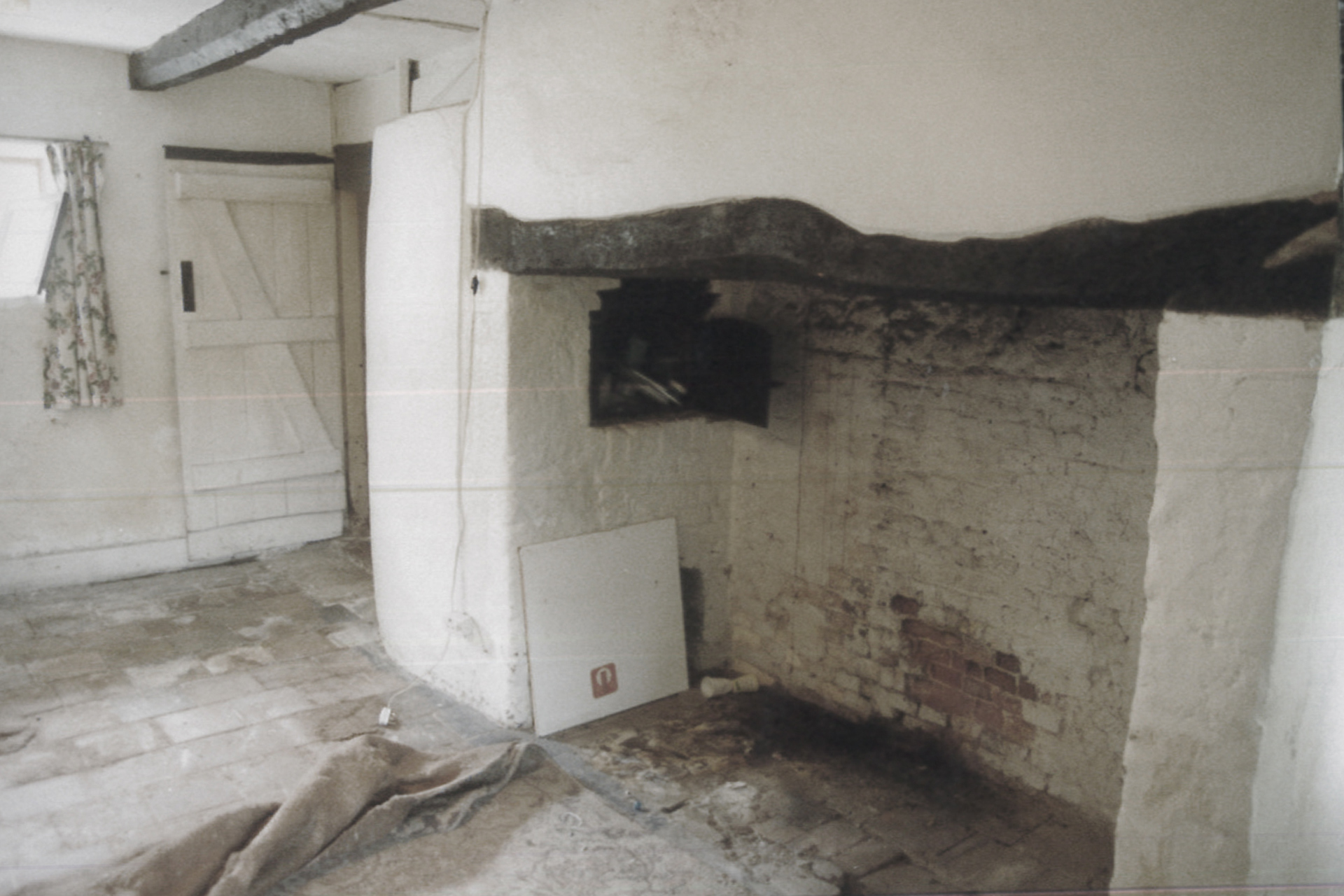 before photo of brick fireplace with timber beam
