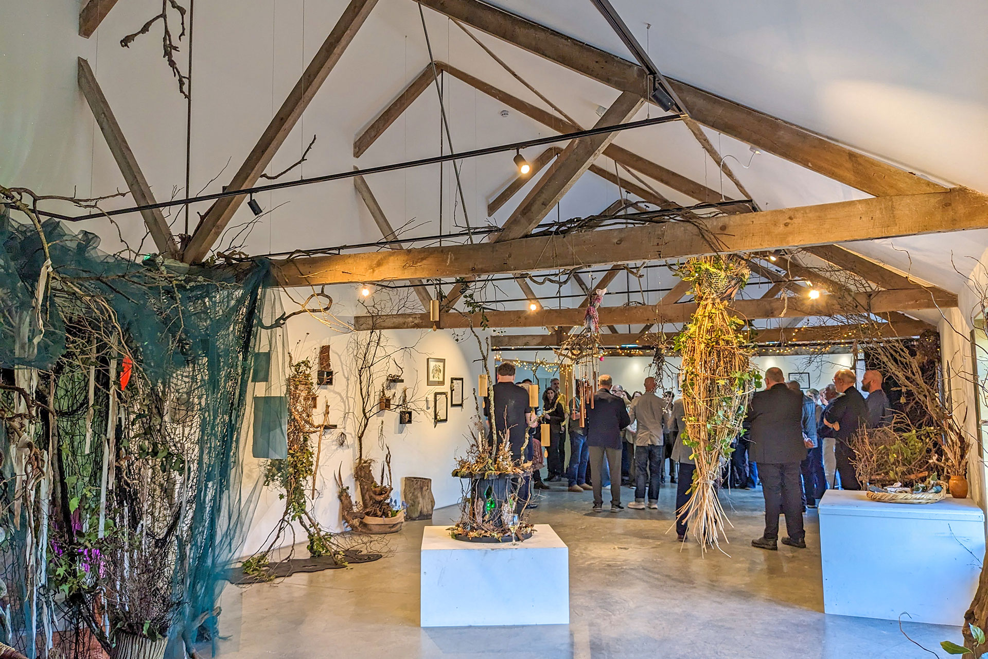 Exhibition space in community building with exposed beams and vaulted ceilings