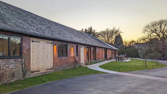 Approach view to barn conversion to community music building with outside seating space