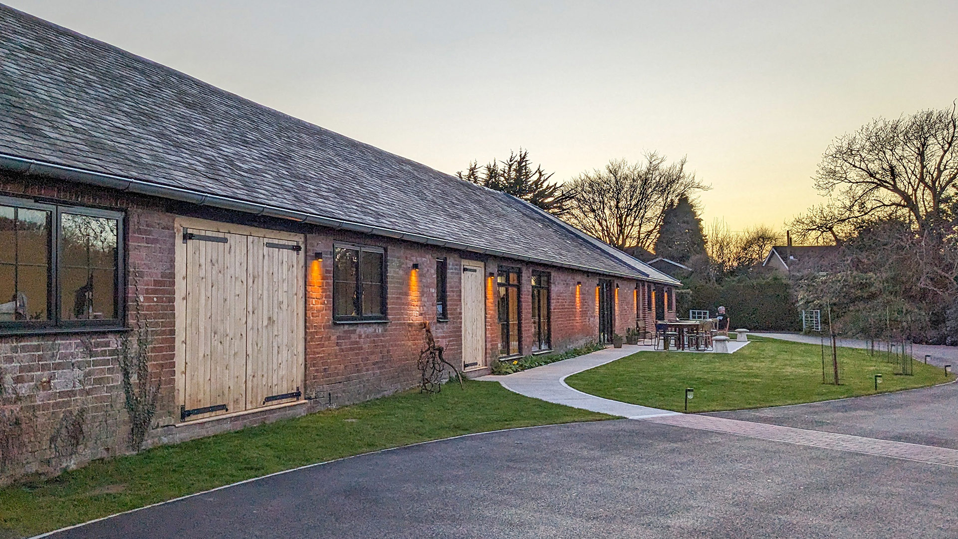 Approach view to barn conversion to community music building with outside seating space
