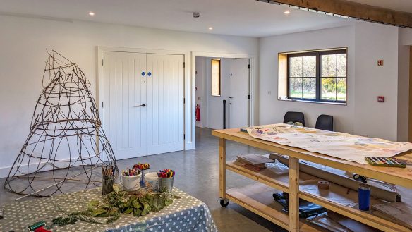 Studio art area in converted barn with concrete polished floors and exposed beams