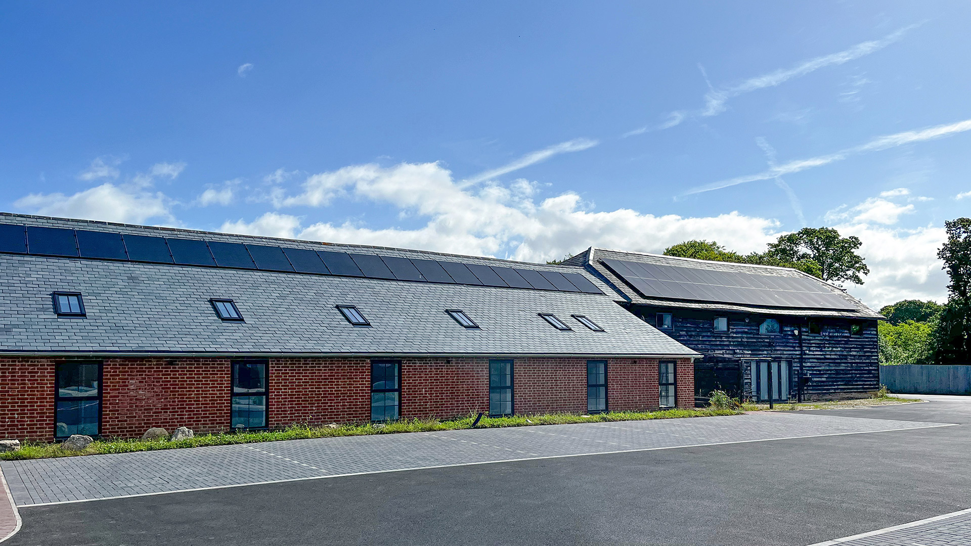 exterior front view of community building with solar panels on the roof