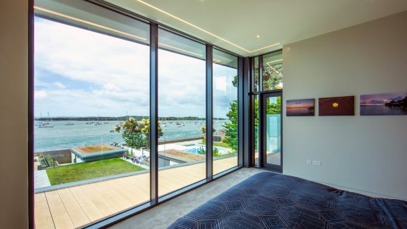 interior bedroom with sliding doors onto balcony with beautiful sea views