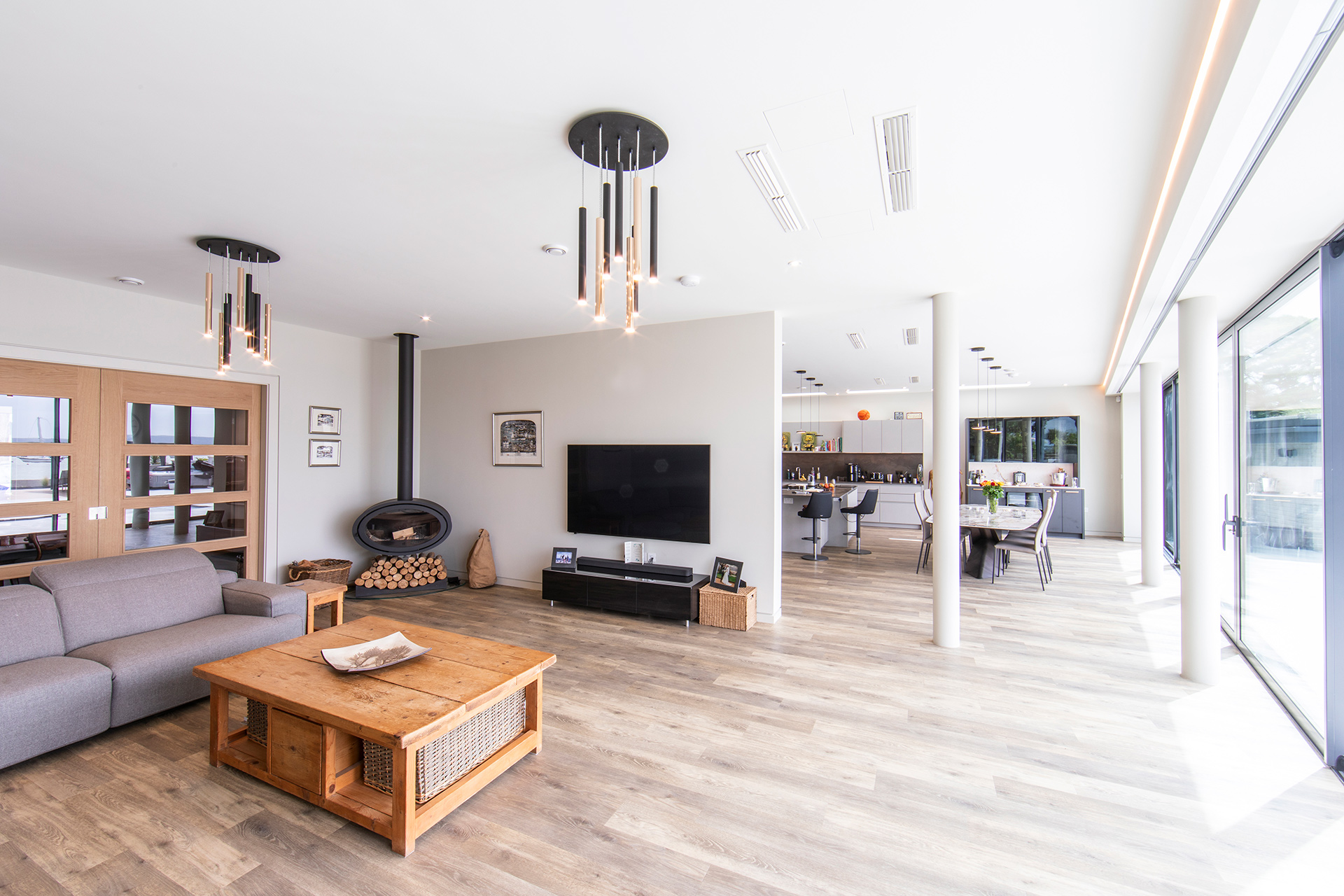open-plan living dining and kitchen room with sliding doors onto patio