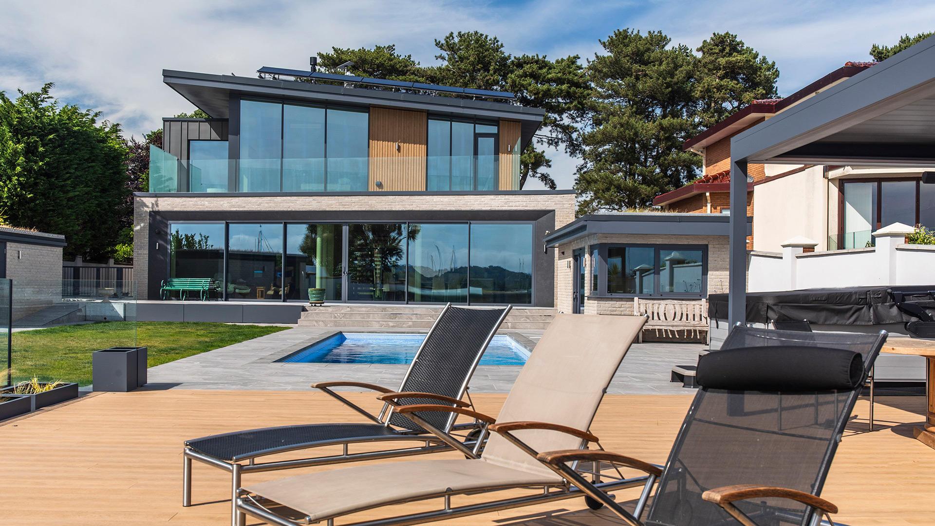 rear view garden with swimming pool and pool chairs