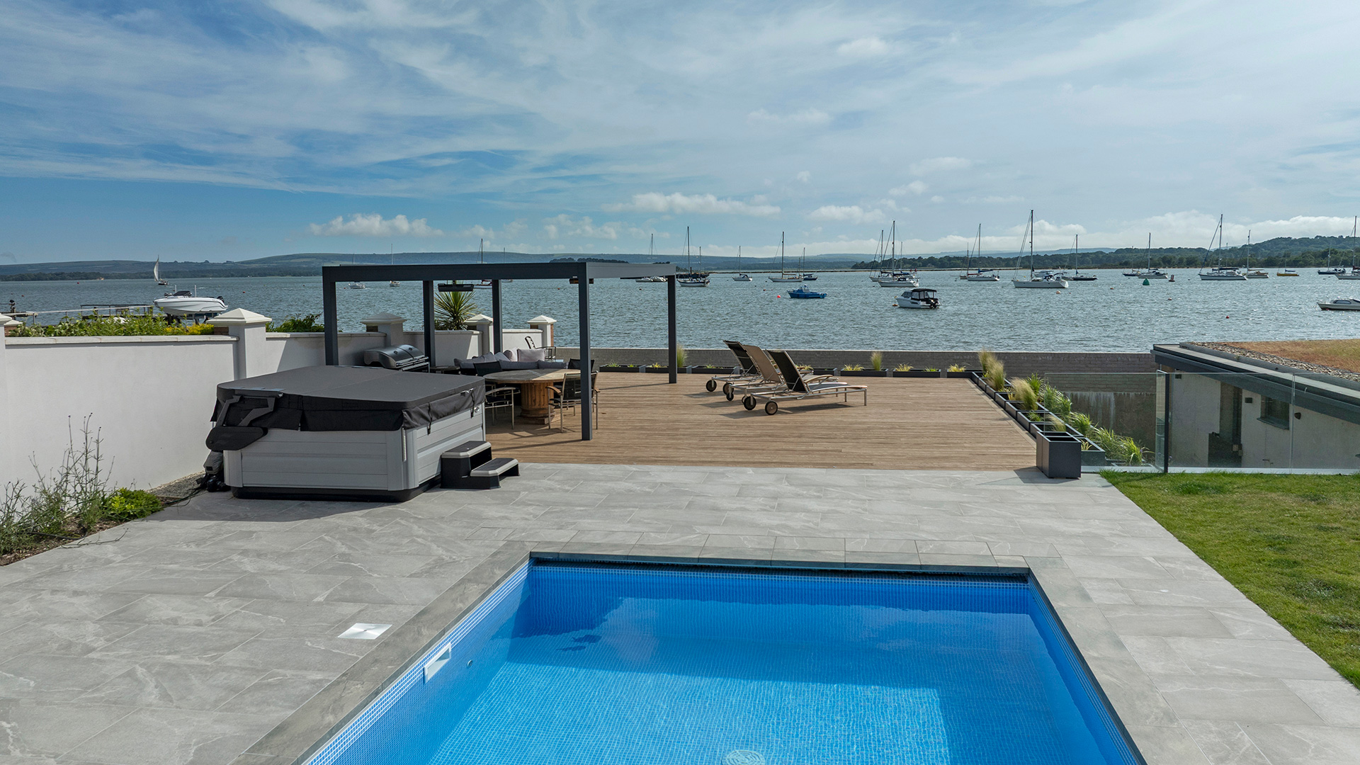 rear garden with swimming pool and sea views