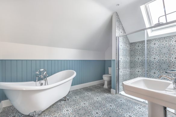 Modern bathroom in white and blue tones with rooflight