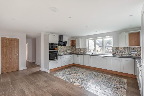 Open plan modern kitchen with mosaic tiles