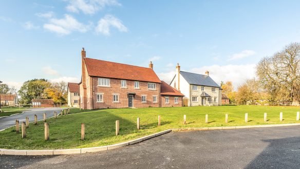 Red brick and red tiled house looking out on to village green area