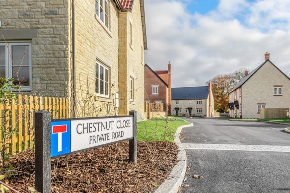 Street scene of new houses with stone walls