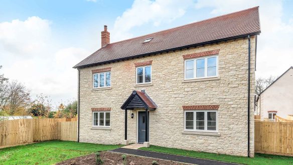 Modern new stone house with traditional double frontage and red tiled roof