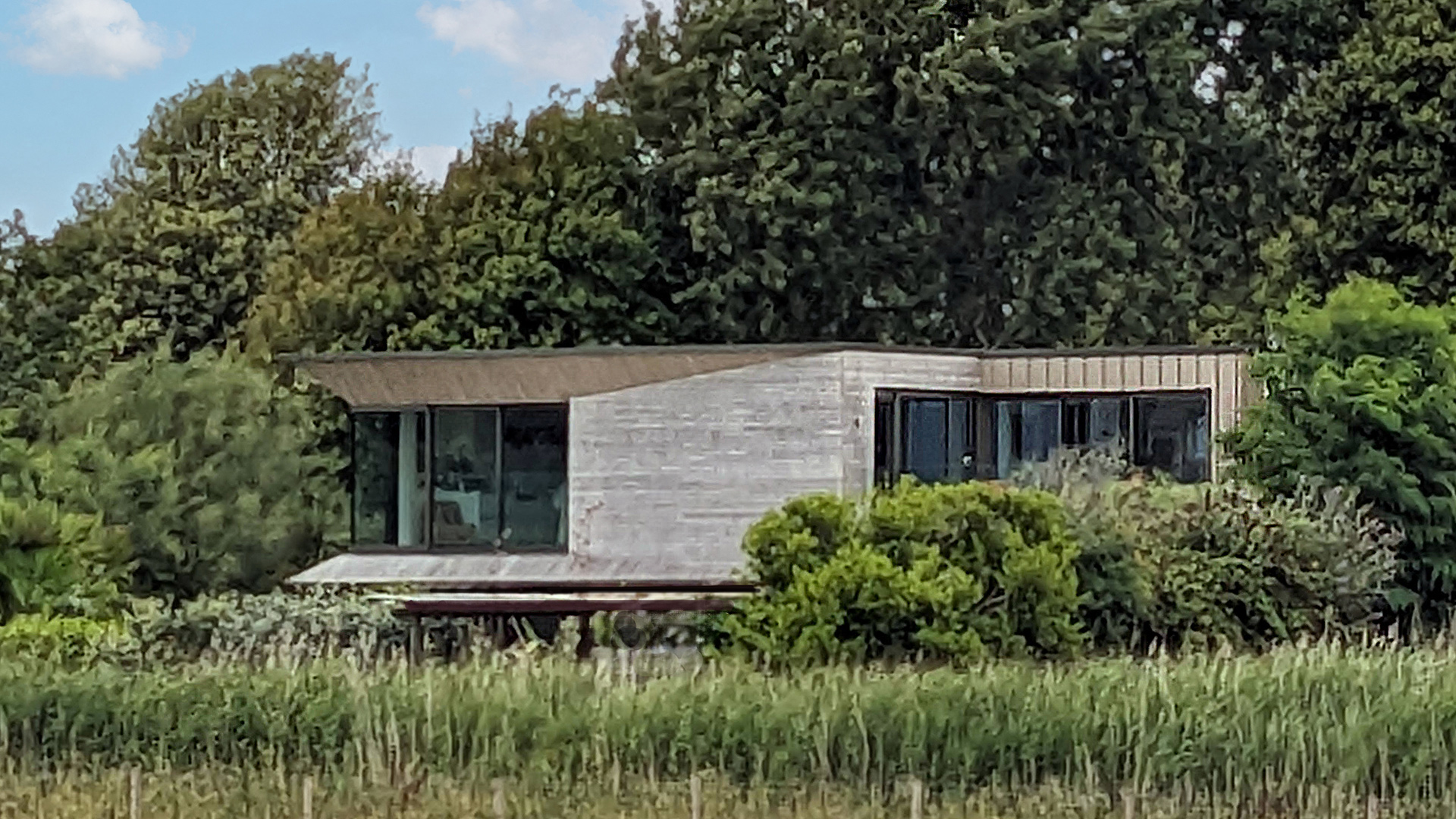 extension of house hidden in trees