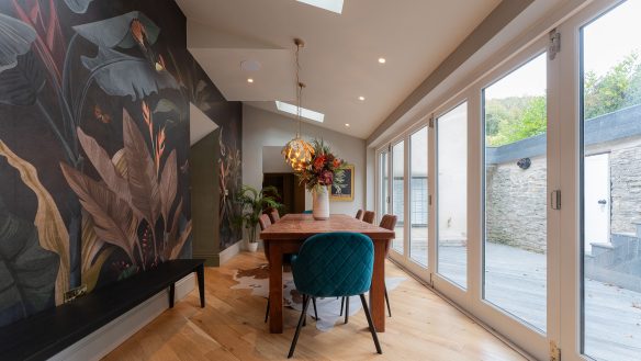 Residential dining room with sloping ceiling and sliding patio doors