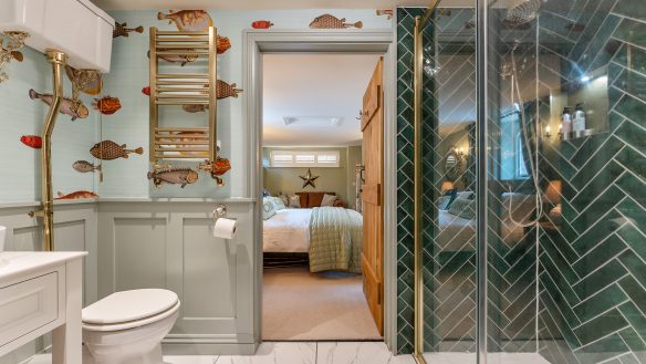 Residential en-suite bathroom with fun fish wallpaper