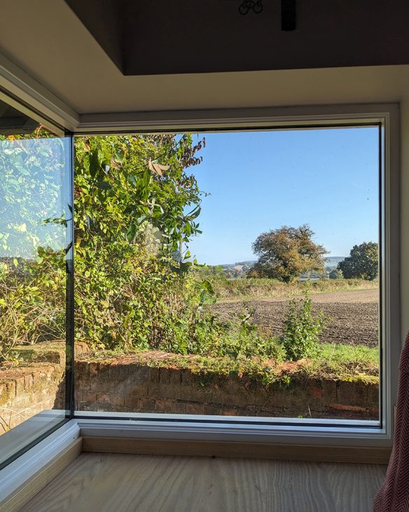 Corner window in kitchen with a view to open countryside