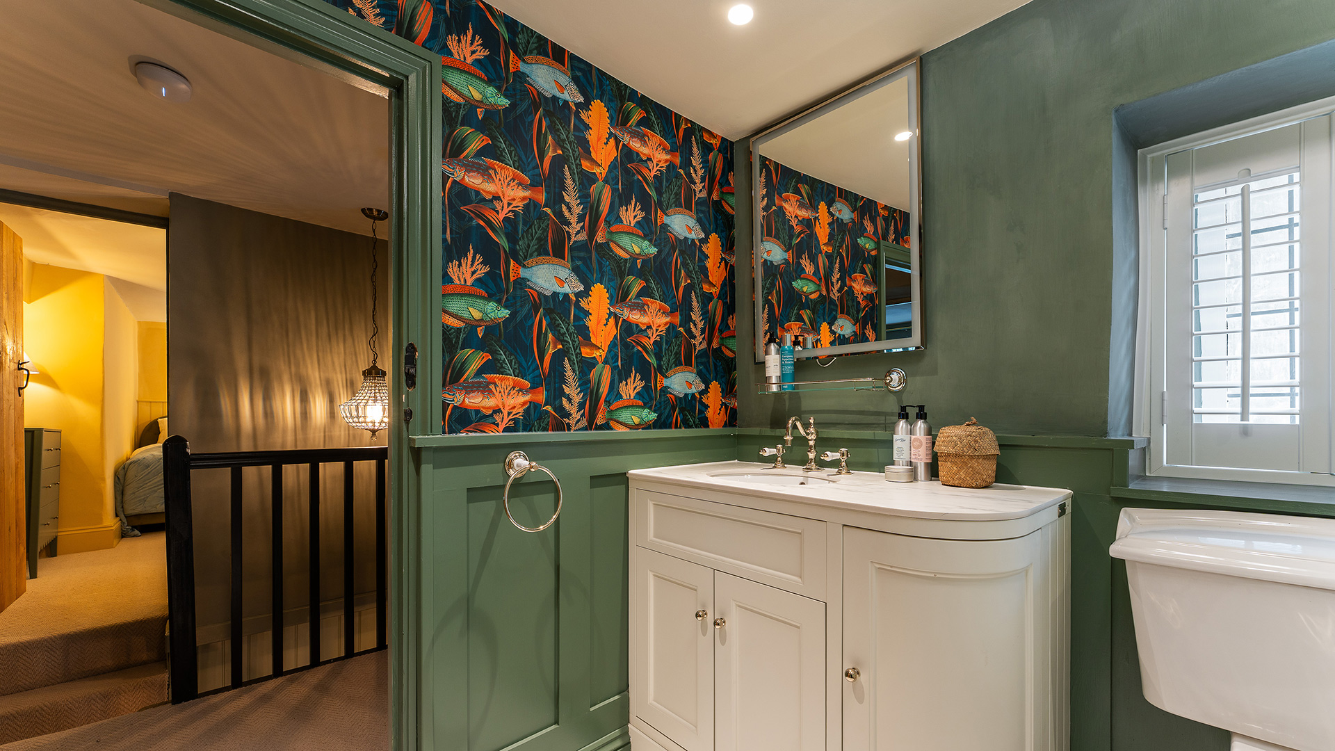 Family bathroom with colourful fish wallpaper
