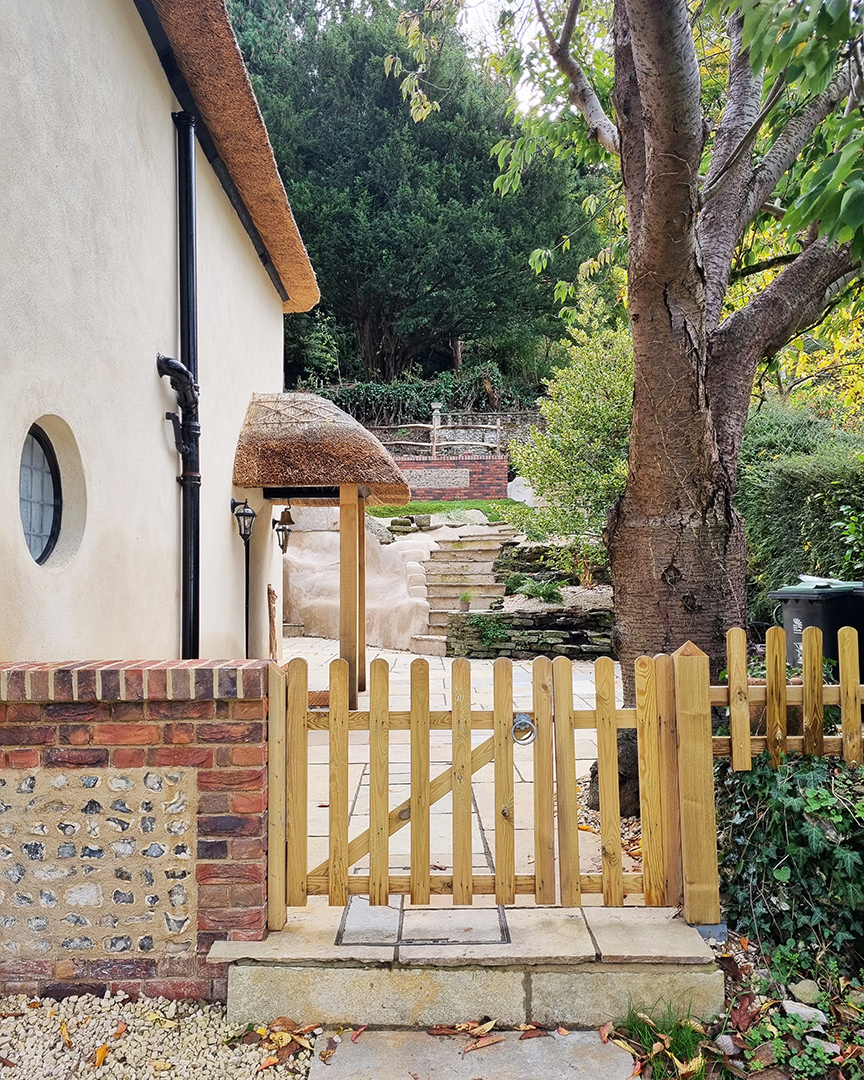 Residential thatched house with side porch entrance