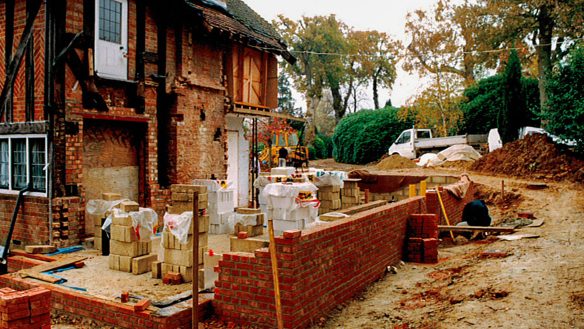 before photo of red brick residential house with extension under construction