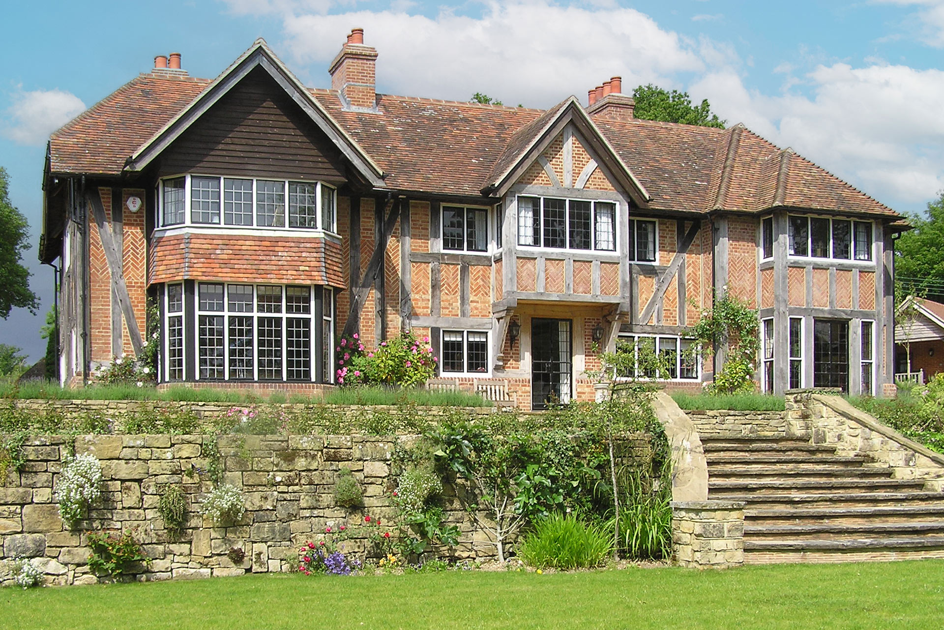Rear elevation of historic house with red brick and timber detail