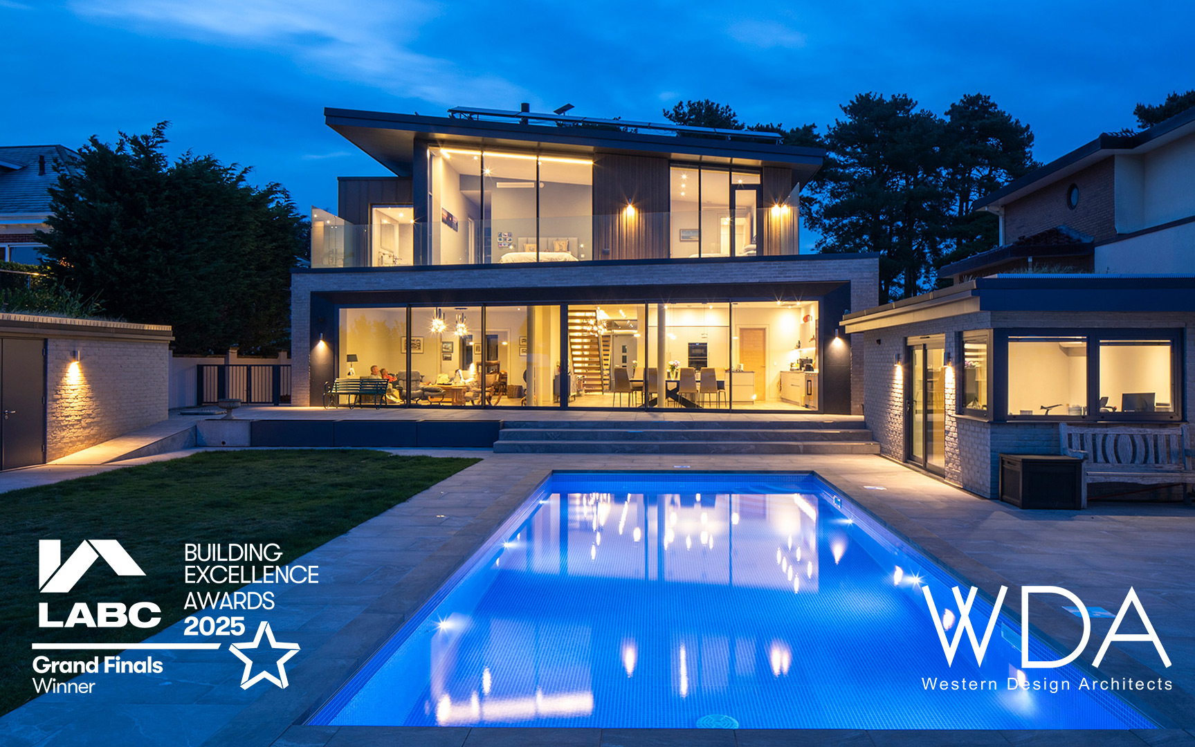 Branksea Avenue house at night with lights on and swimming pool. LABC Building Excellence awards 2025 winner advert
