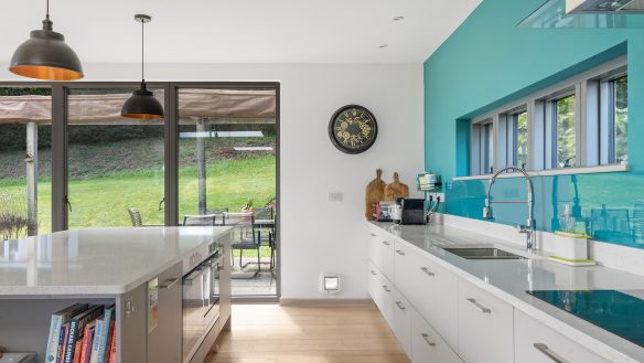 modern kitchen interior with turquoise feature wall and kitchen island