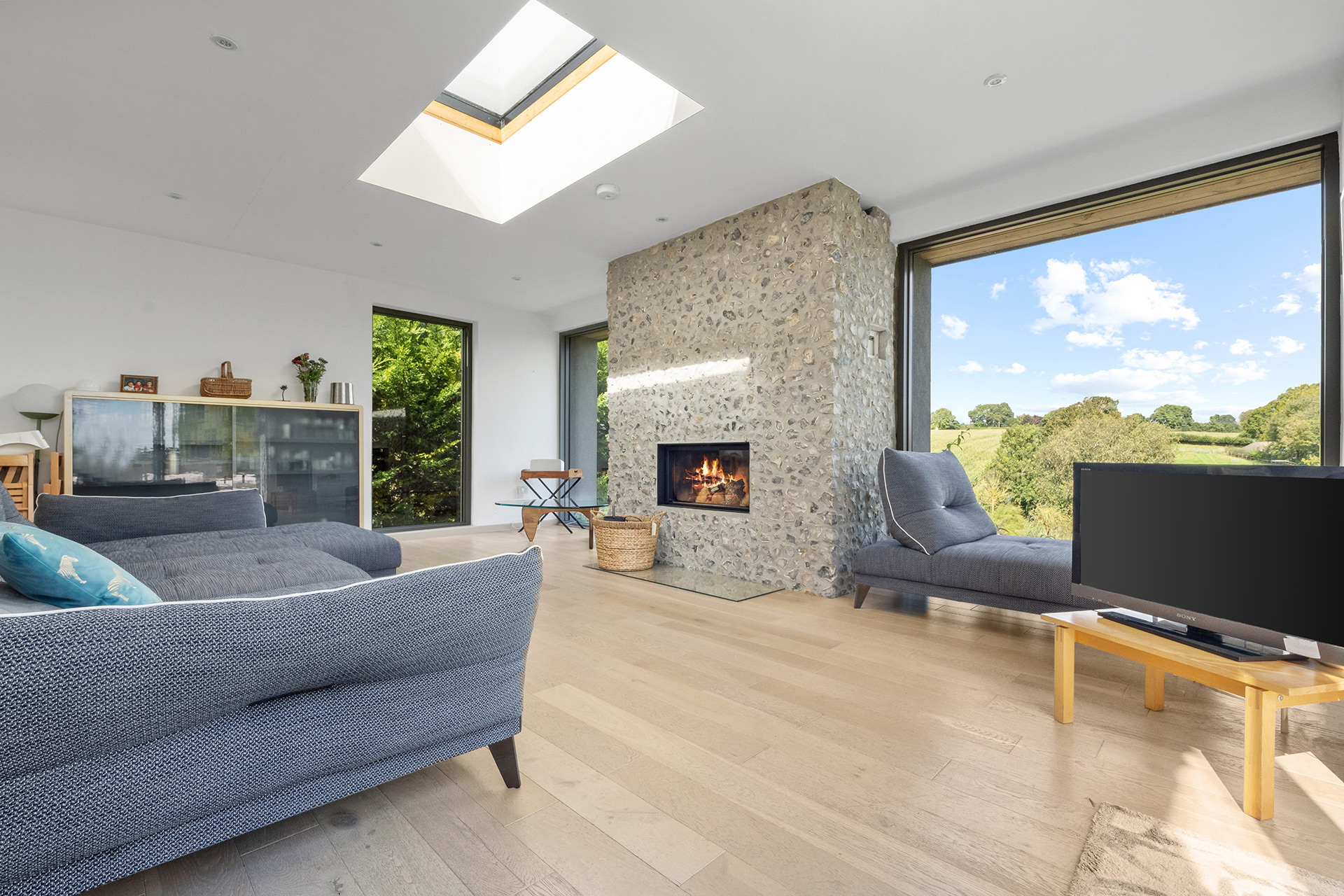 residential modern new home with feature flint fireplace
