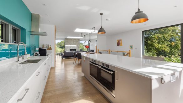 open plan modern kitchen living room in residential new house with large kitchen island