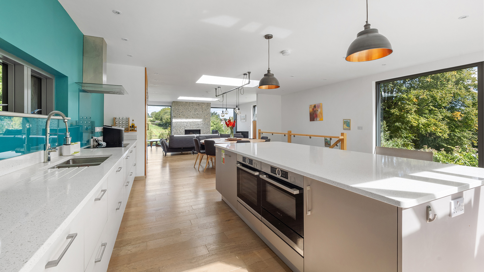 open plan modern kitchen living room in residential new house with large kitchen island