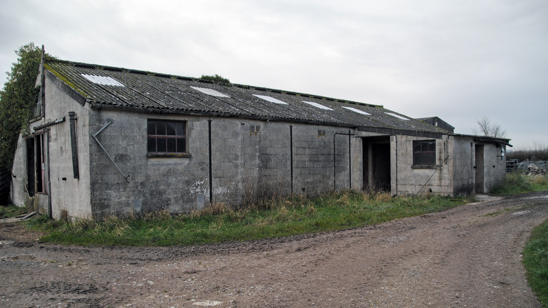 Before photo of existing barn with corrugated roof