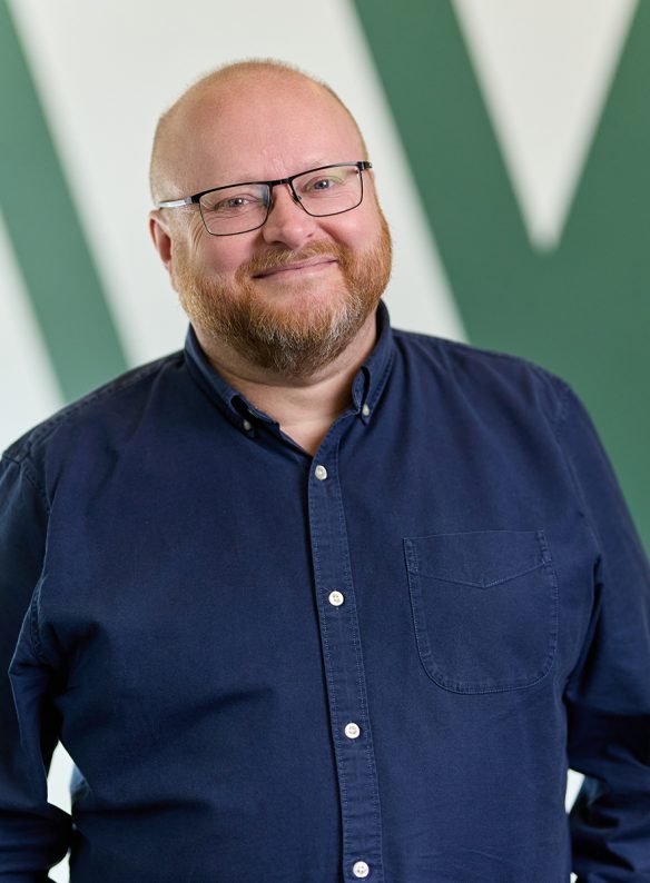 Man smiling in a blue shirt