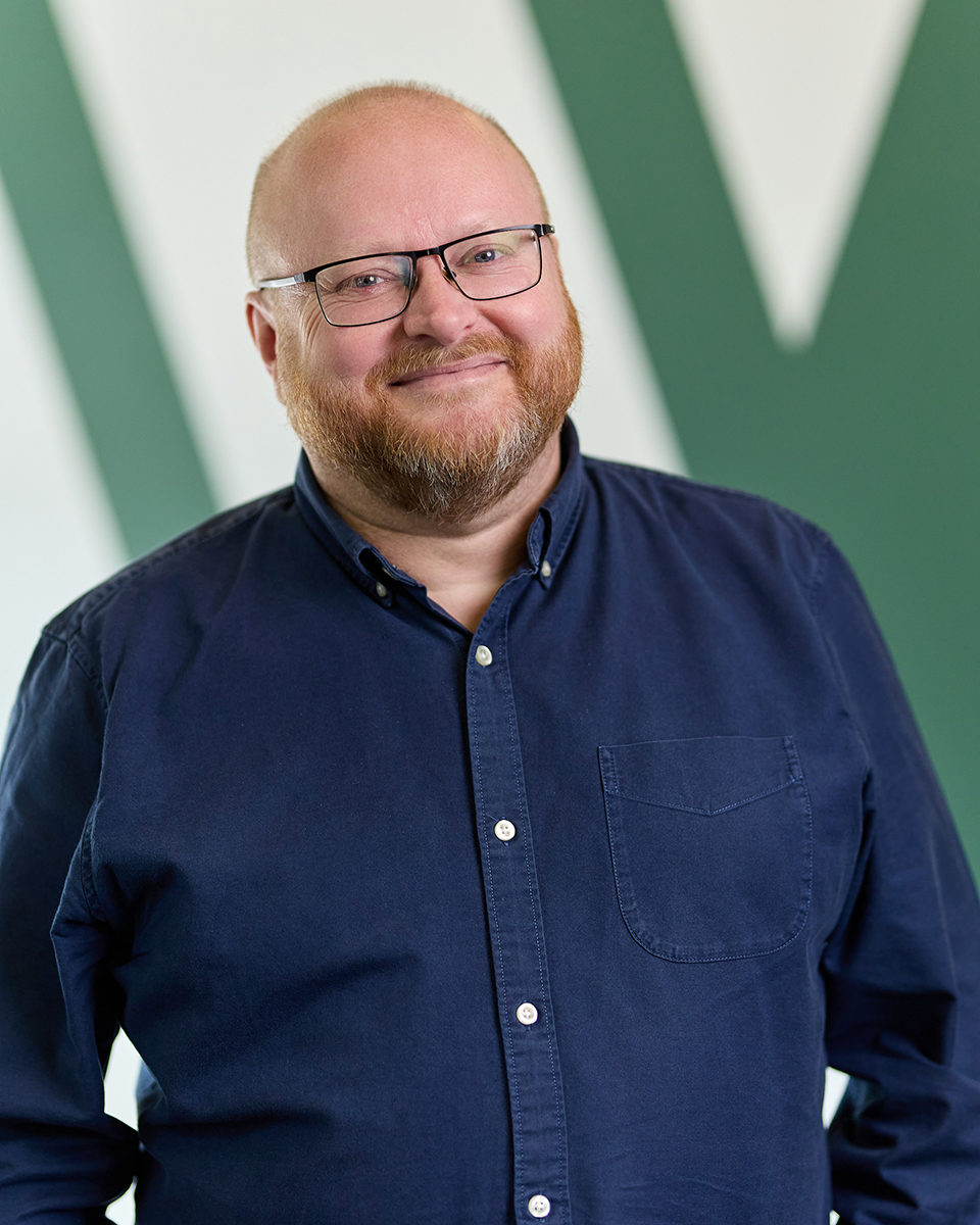Man smiling in a blue shirt