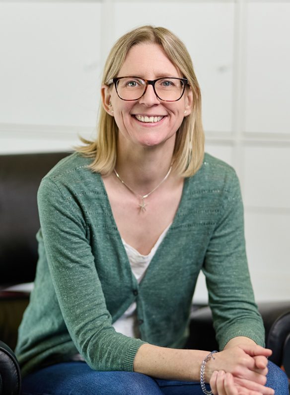 lady with glasses smiling at camera