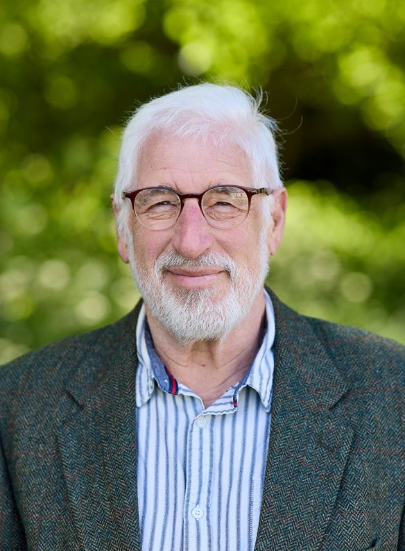 man in shirt and blazer with round glasses