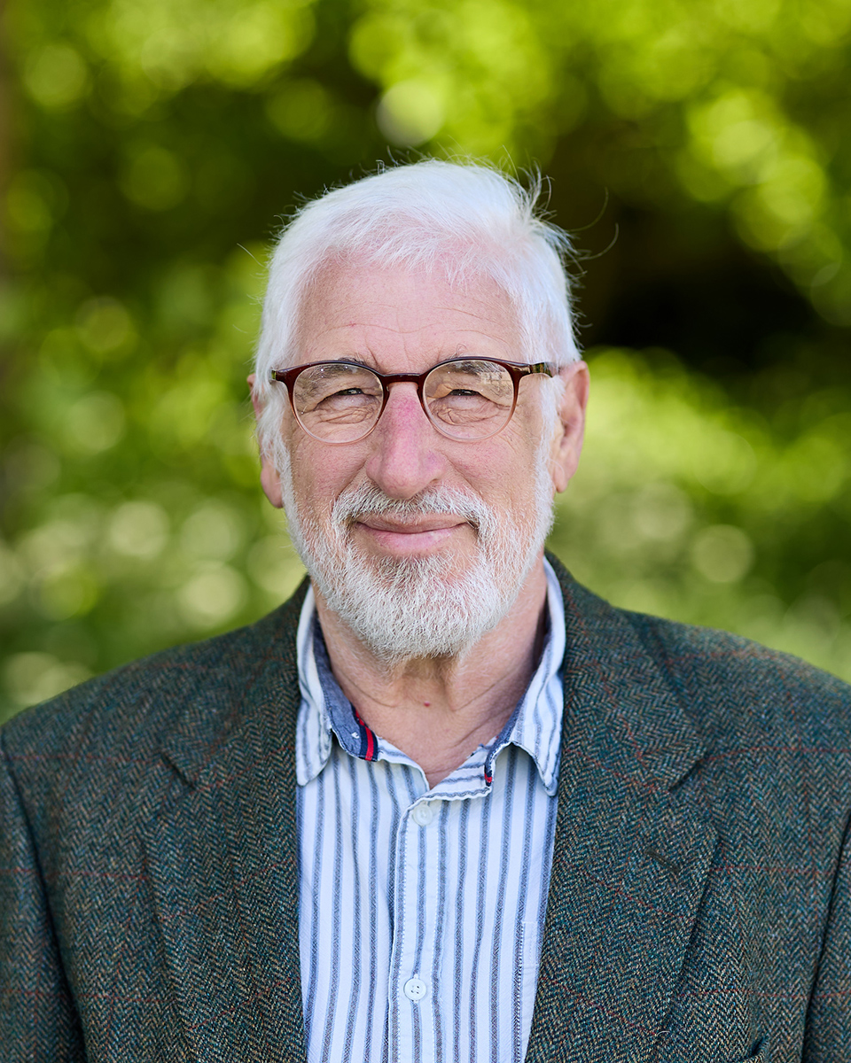 man in shirt and blazer with round glasses