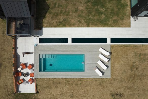 aerial view of rectangular swimming pool, decking and sunken seating area